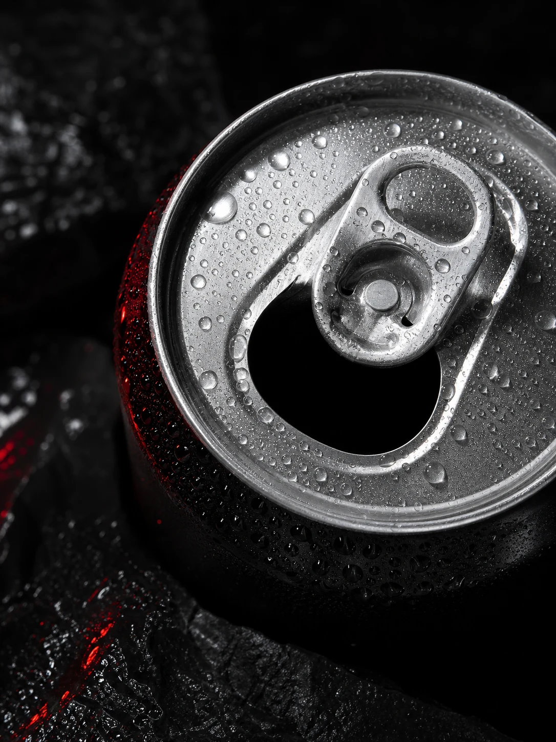 Macro study of an opened black aluminium can served cold