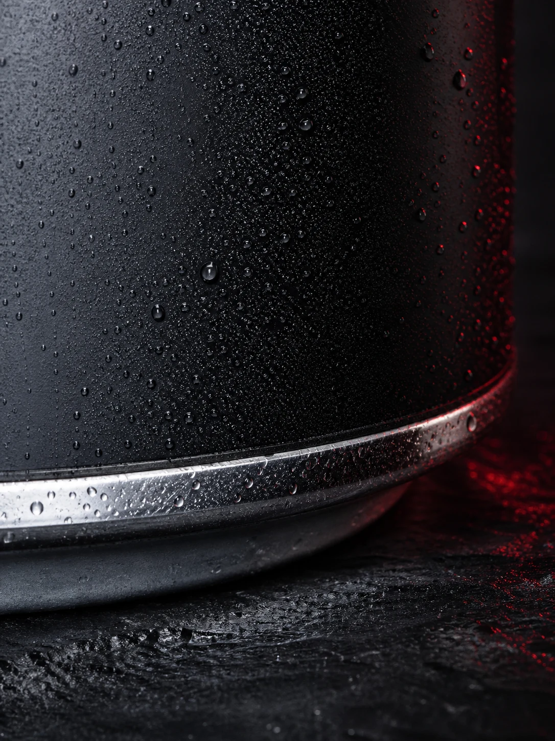 Macro study of the lower seam on a chilled matte-black aluminium can